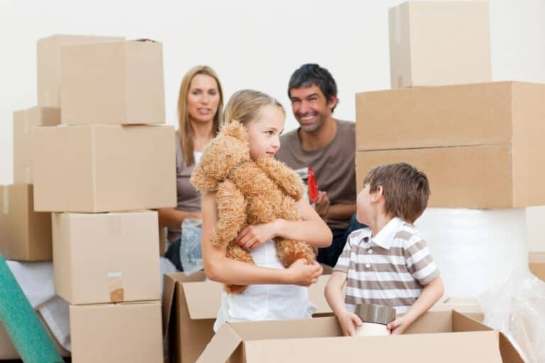 A family of four is unpacking boxes after moving in.