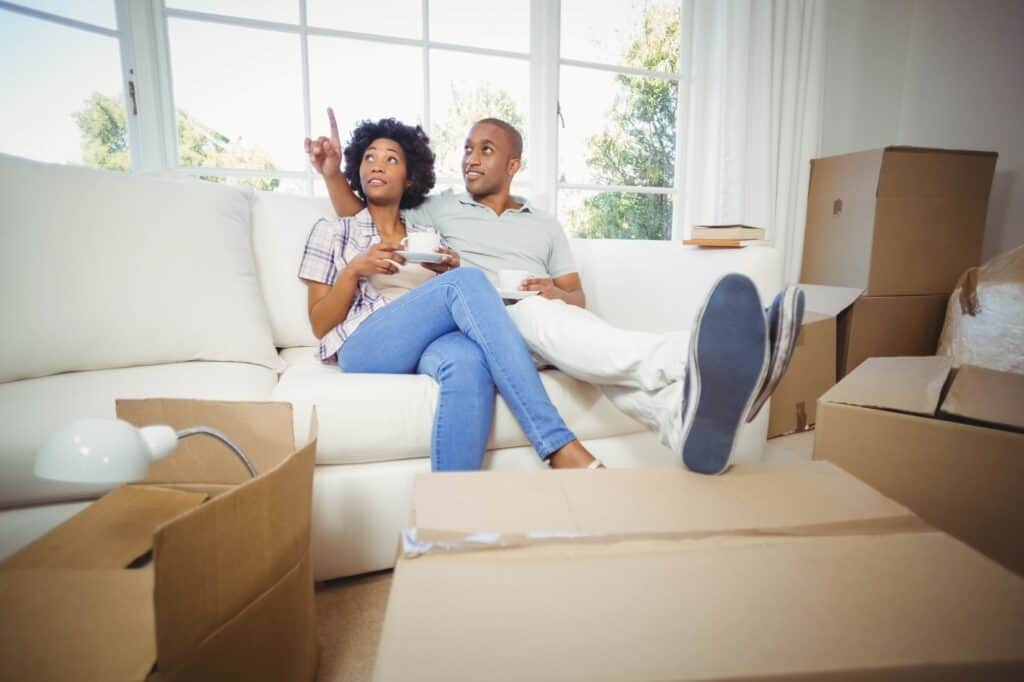 A couple is having a coffee upon moving into their new house